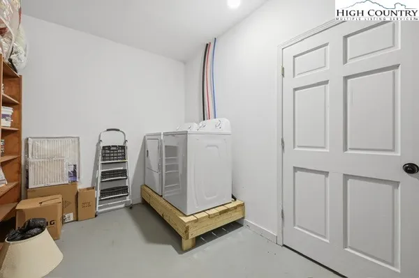 a kitchen with refrigerator a stove and chairs