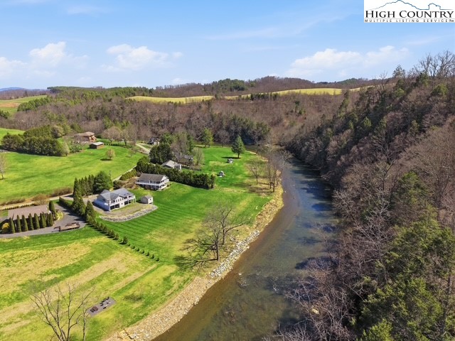 154 Beau Rivage Drive Crumpler, NC 28617 - Photo 4 of 34 a view of a garden with mountains in the background
