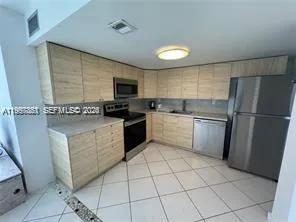 a kitchen with a sink a stove top oven and cabinets