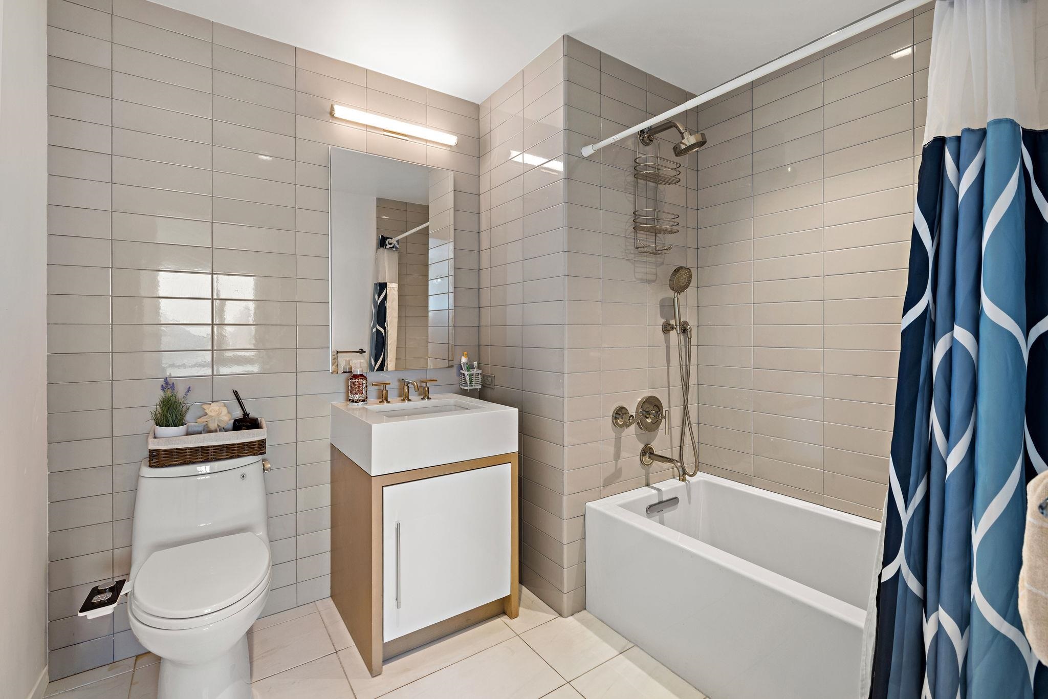 75 Park Lane South, Unit 1607 Jersey City, NJ 07310 - Photo 12 of 20 a bathroom with a sink toilet and shower