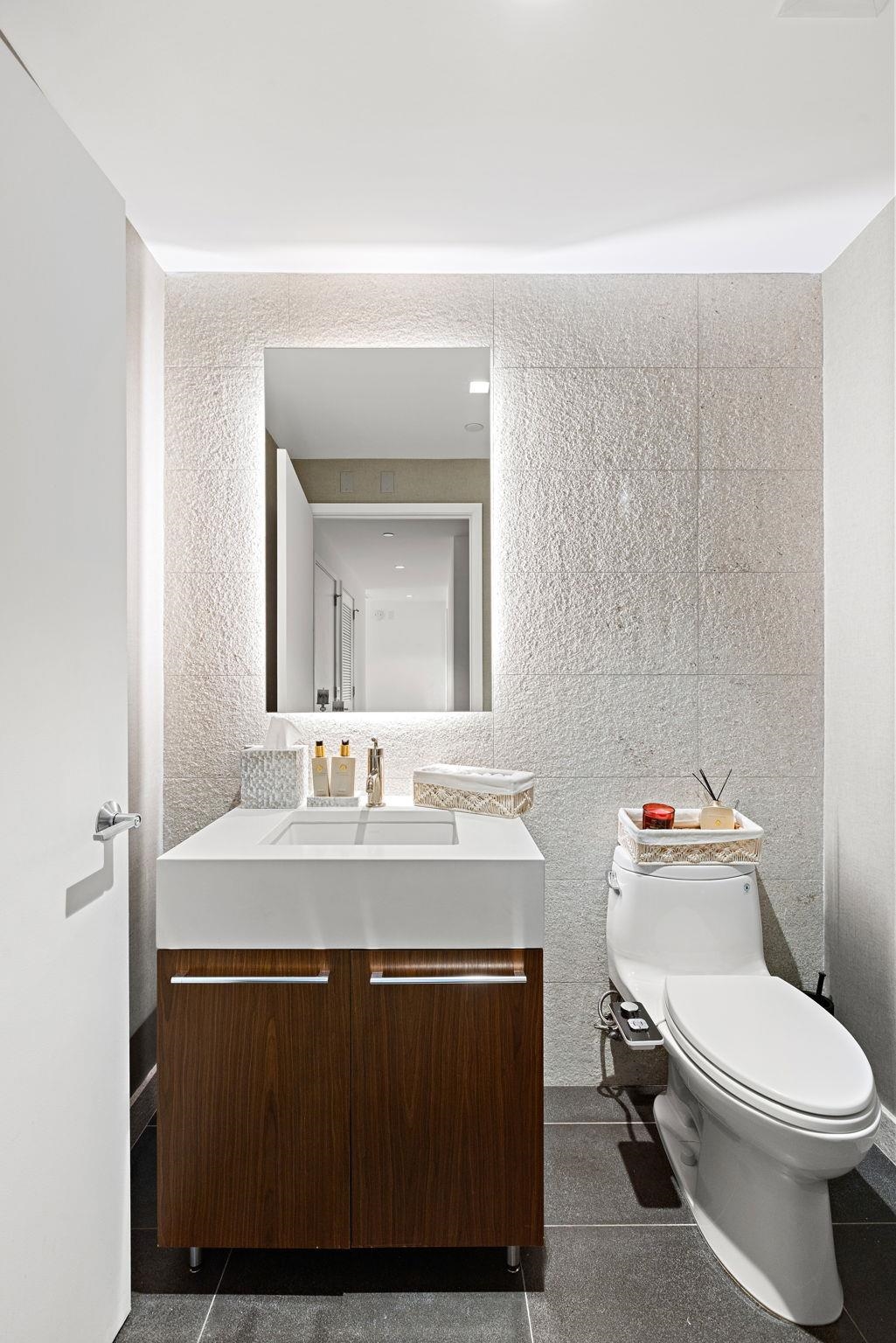 75 Park Lane South, Unit 1607 Jersey City, NJ 07310 - Photo 15 of 20 a bathroom with a sink toilet vanity and mirror