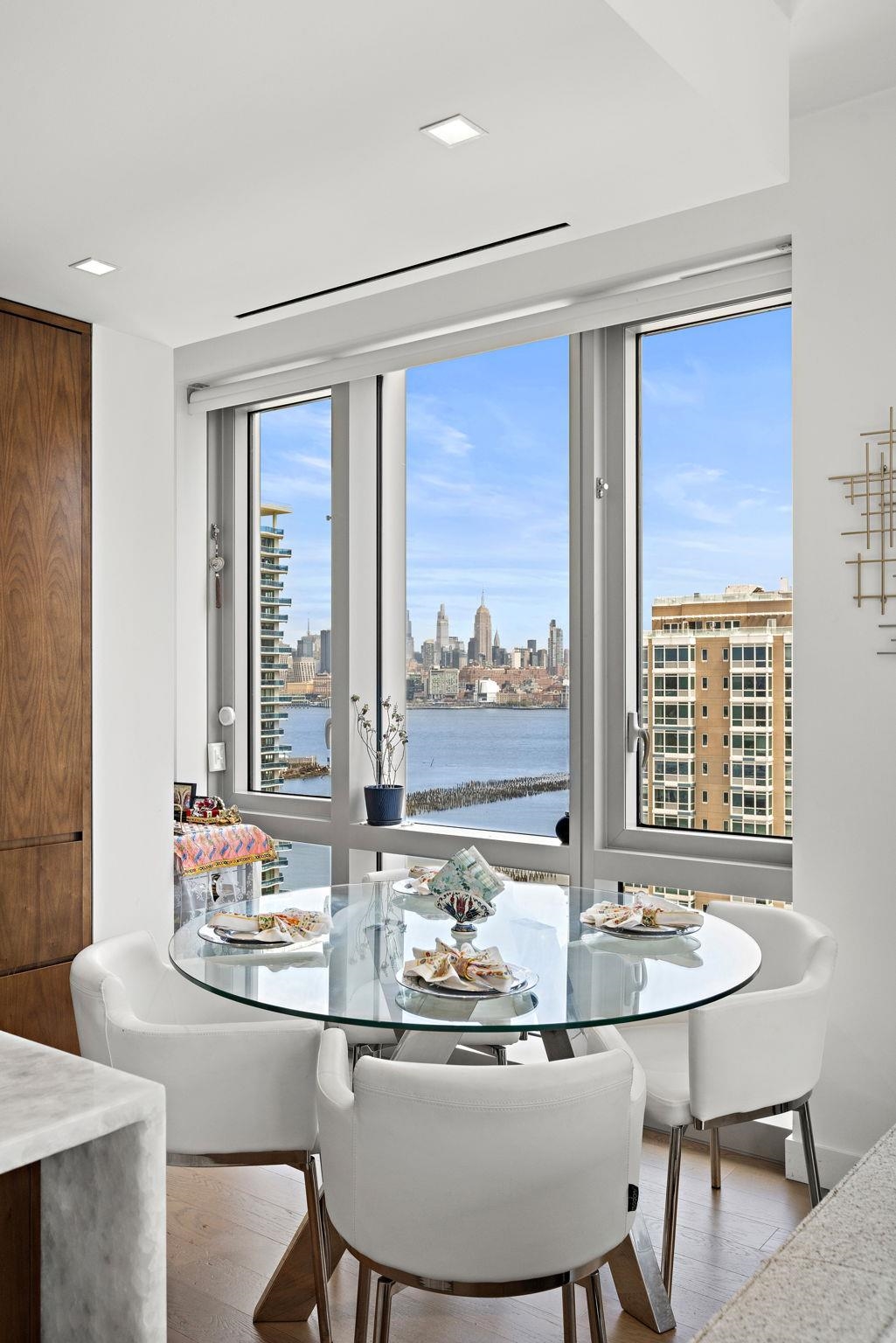 75 Park Lane South, Unit 1607 Jersey City, NJ 07310 - Photo 8 of 20 a dining room with furniture and window
