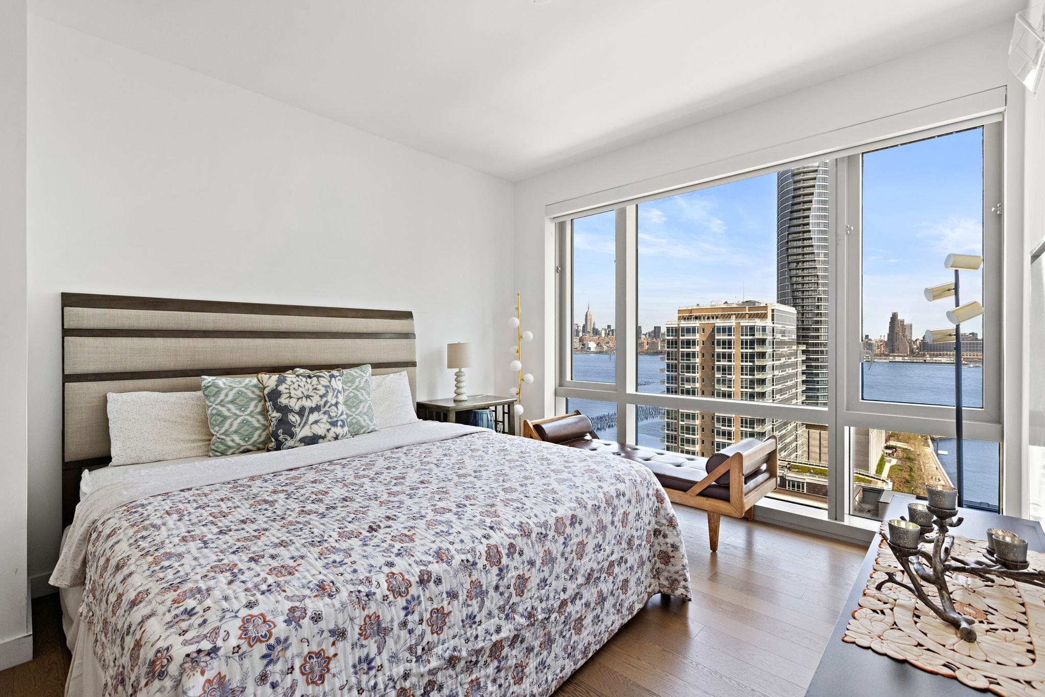 75 Park Lane South, Unit 1607 Jersey City, NJ 07310 - Photo 9 of 20 a bedroom with a large bed and a large window