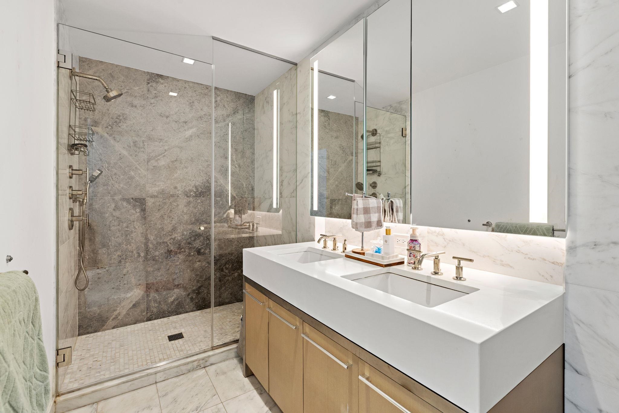 75 Park Lane South, Unit 1607 Jersey City, NJ 07310 - Photo 10 of 20 a bathroom with a sink shower and a mirror