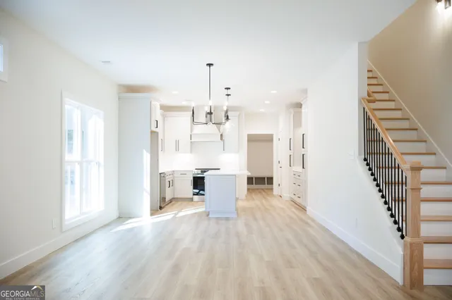 a view of a kitchen with wooden floor and electronic appliances