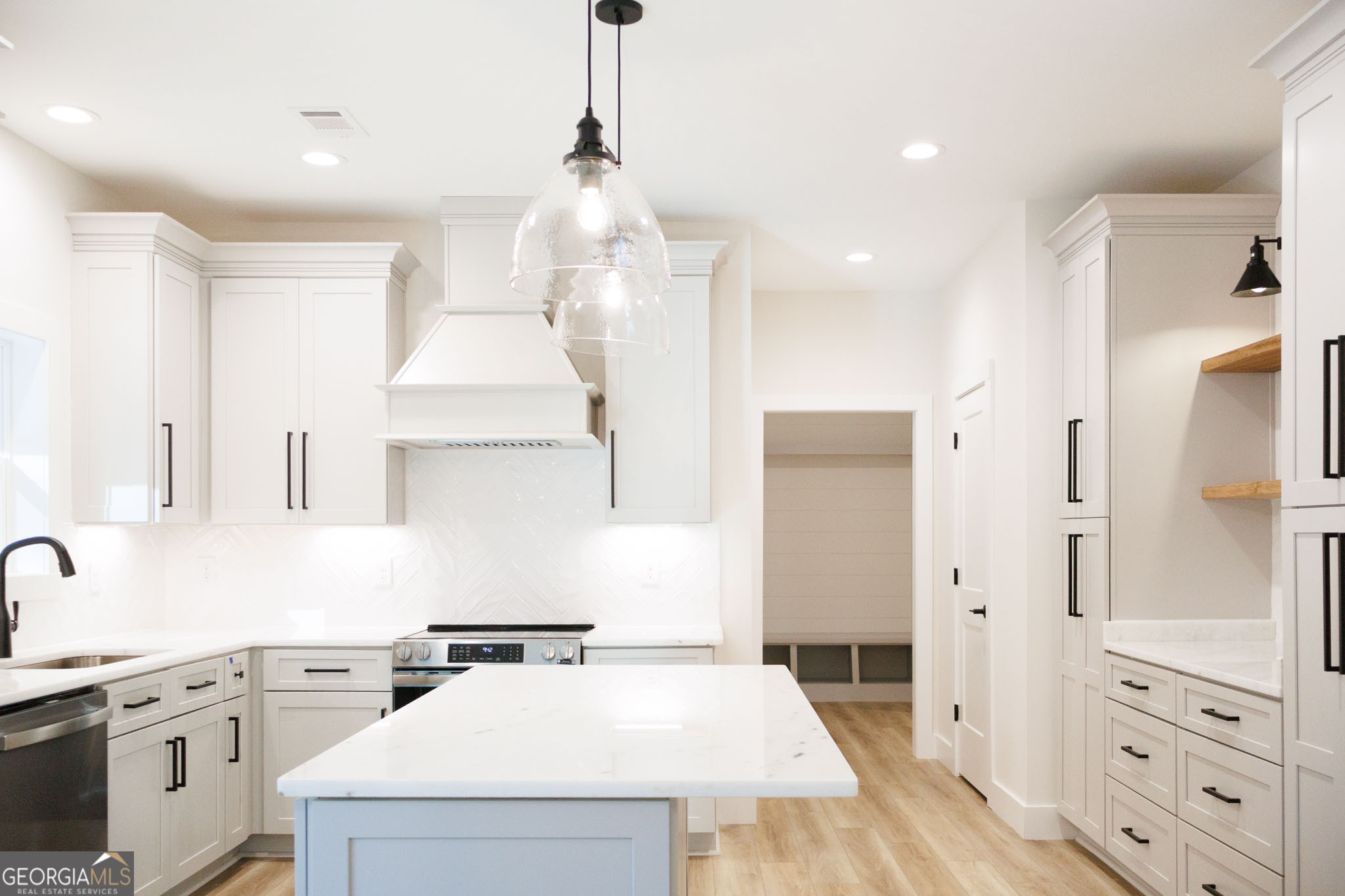 903 Massee Lane Perry, GA 31069 - Photo 13 of 26 a kitchen with a stove a sink and a refrigerator