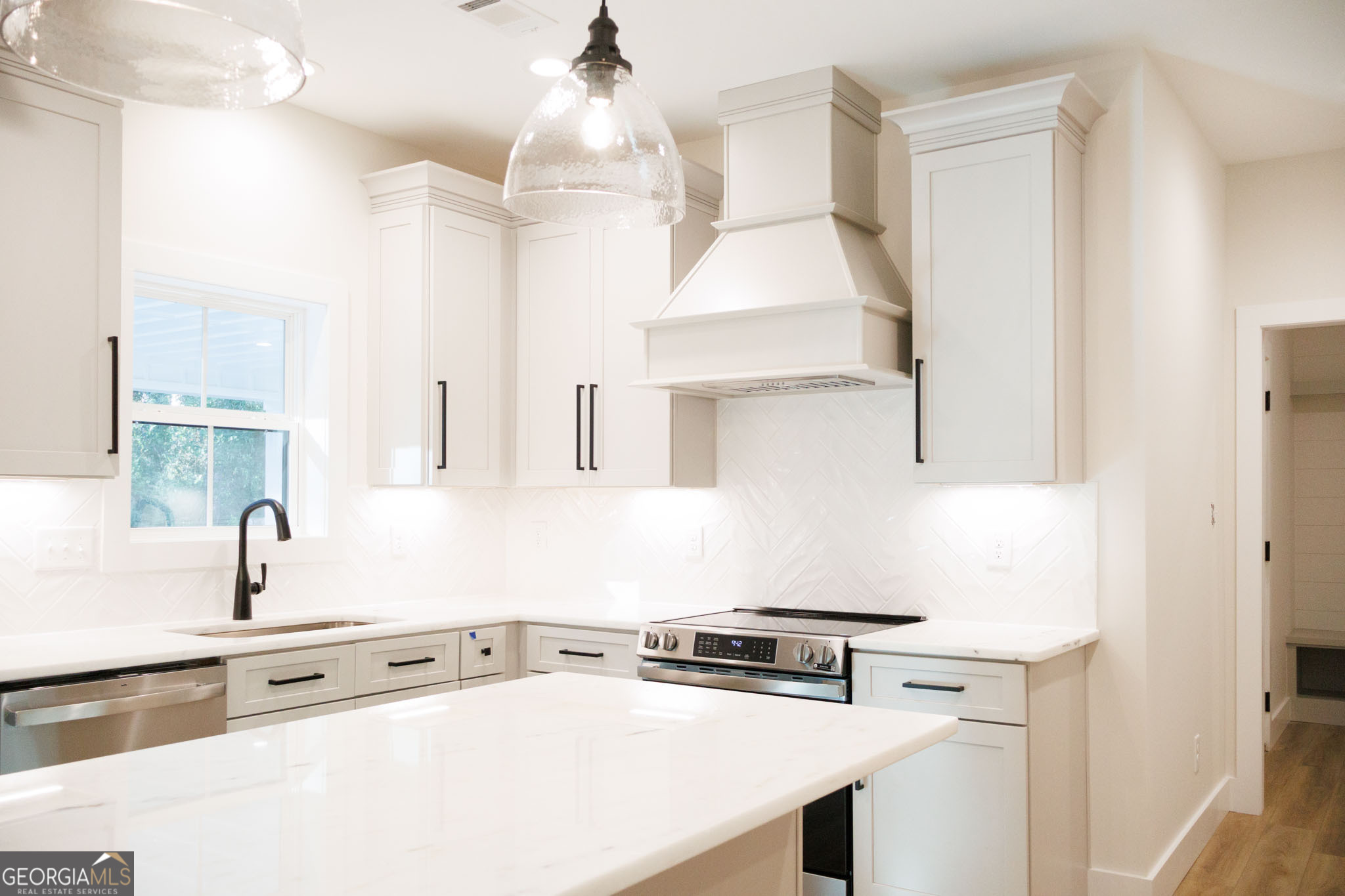 903 Massee Lane Perry, GA 31069 - Photo 14 of 26 a kitchen with stainless steel appliances a sink a stove and a refrigerator