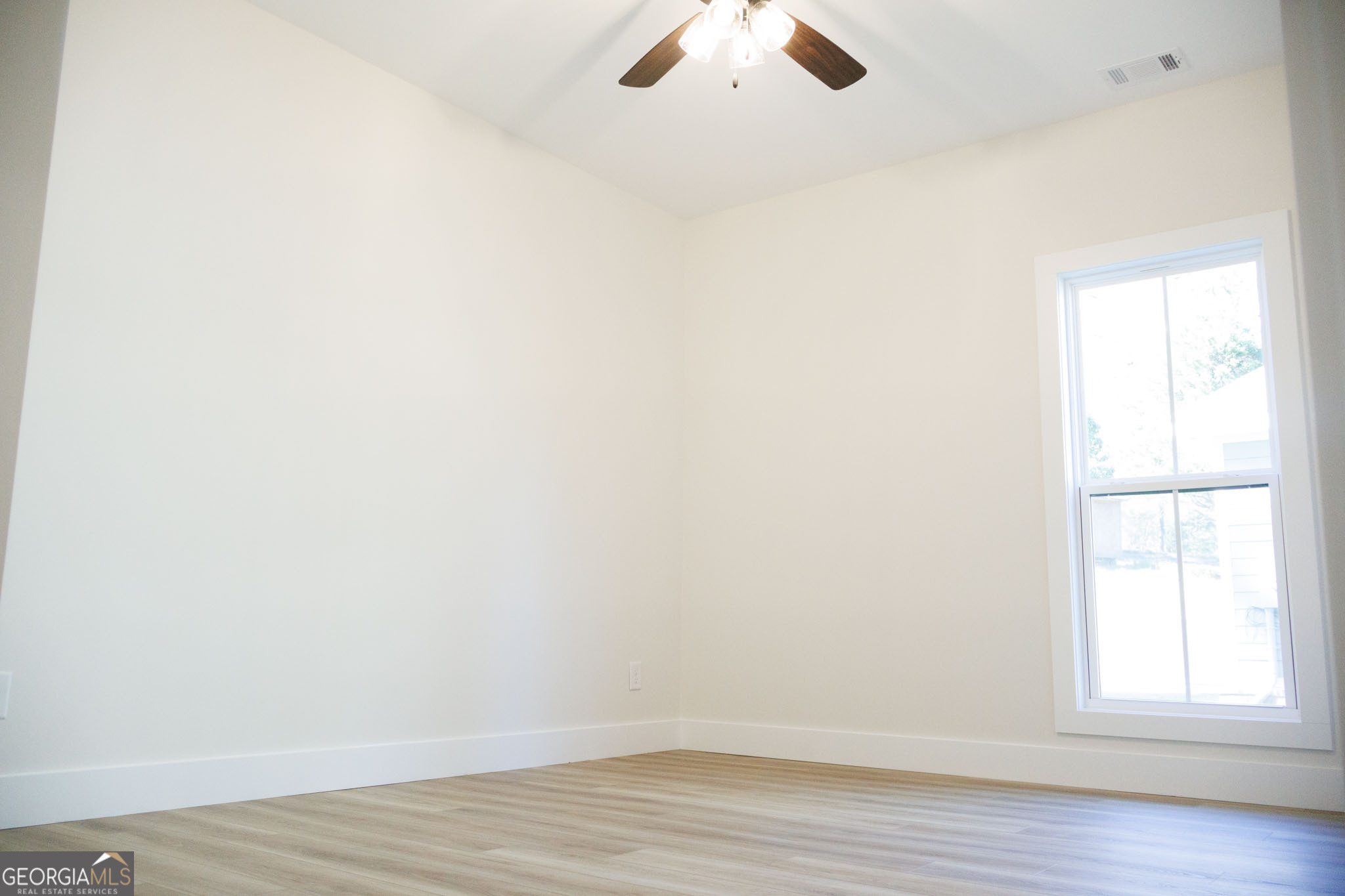 903 Massee Lane Perry, GA 31069 - Photo 22 of 26 an empty room with wooden floor and windows