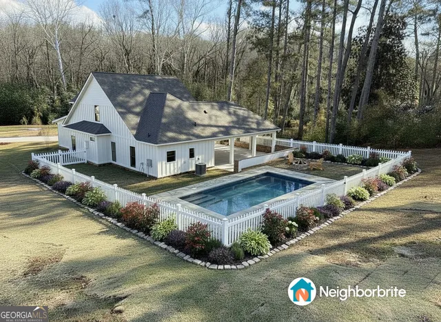 an aerial view of a house with swimming pool