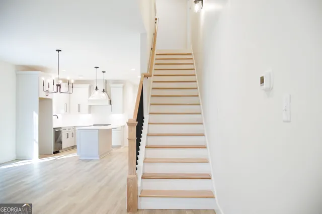 a view of kitchen with sink and refrigerator