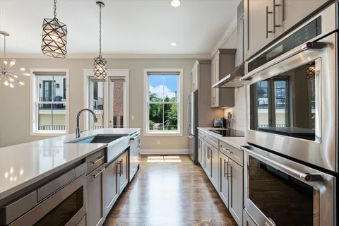 a kitchen with stainless steel appliances a refrigerator and cabinets