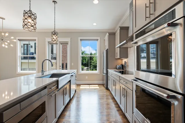 a kitchen with stainless steel appliances a refrigerator and cabinets
