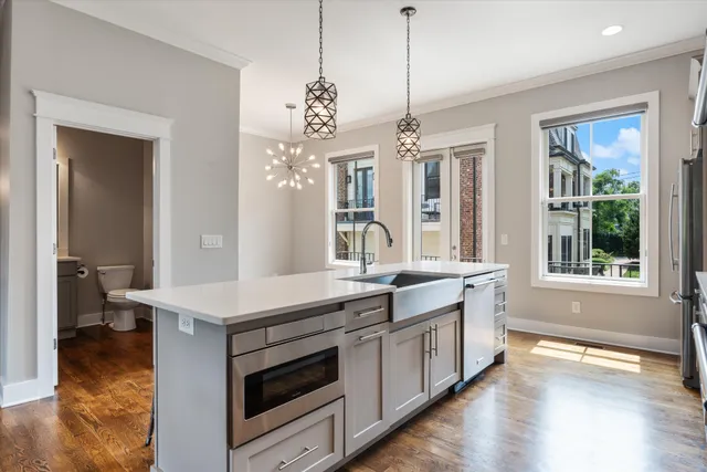 a kitchen with a stove a sink and a refrigerator