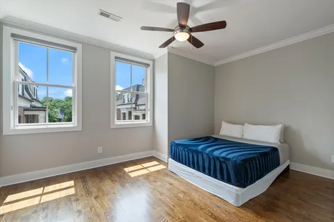 a bedroom with a bed and wooden floor