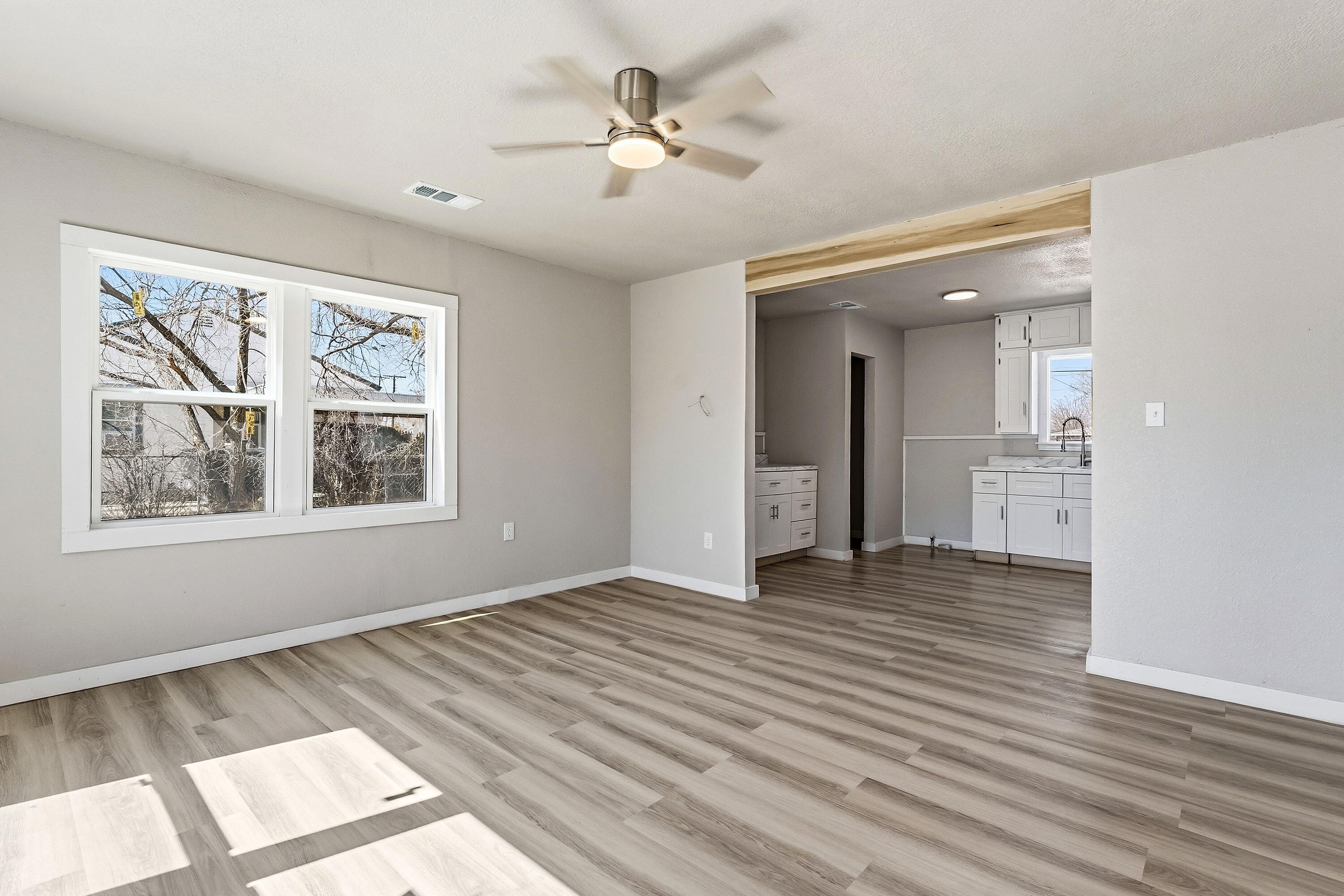 2814 40th Street Lubbock, TX 79413 - Photo 2 of 10 an empty room with wooden floor and windows