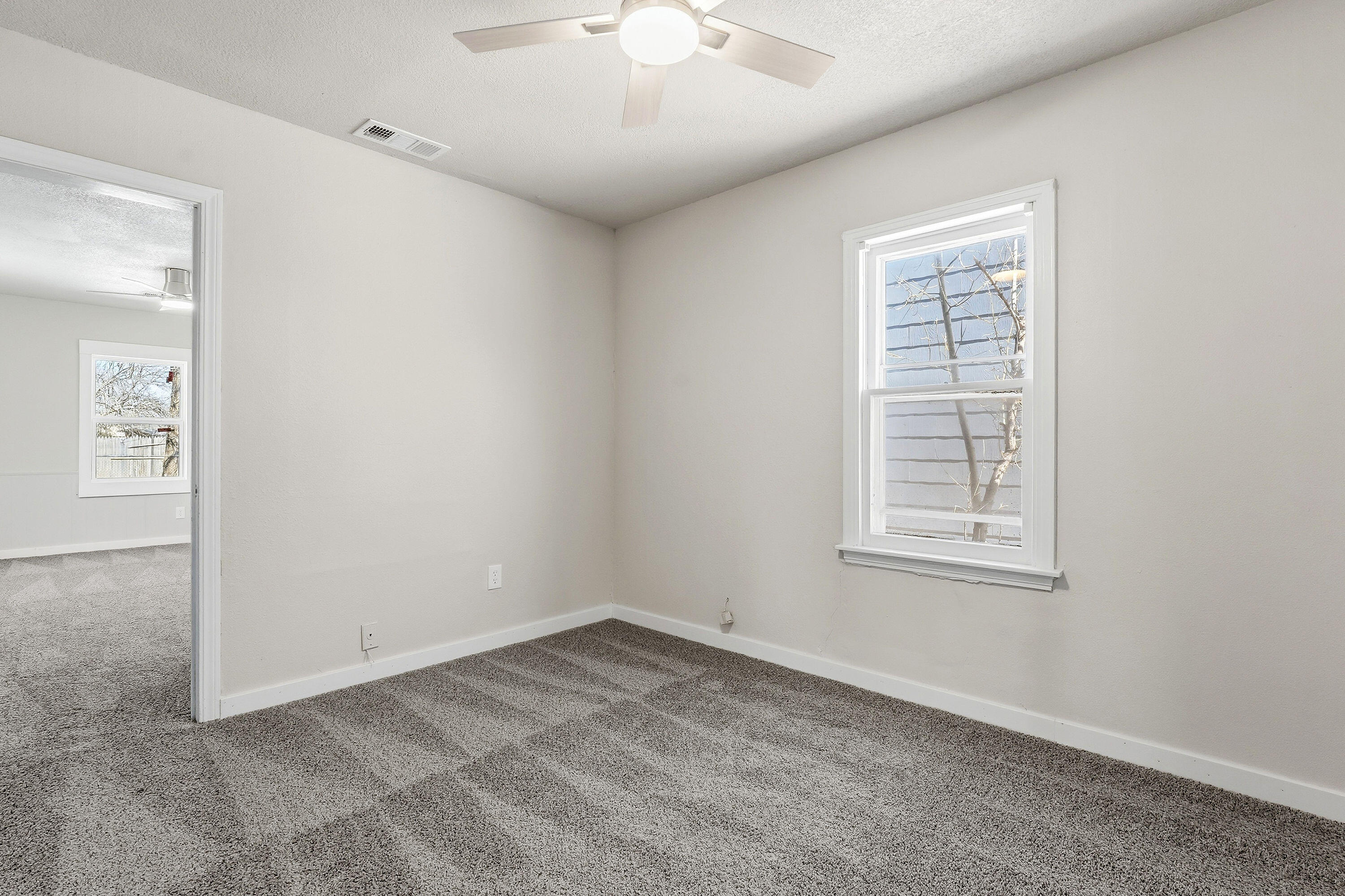 2814 40th Street Lubbock, TX 79413 - Photo 6 of 10 an empty room with windows