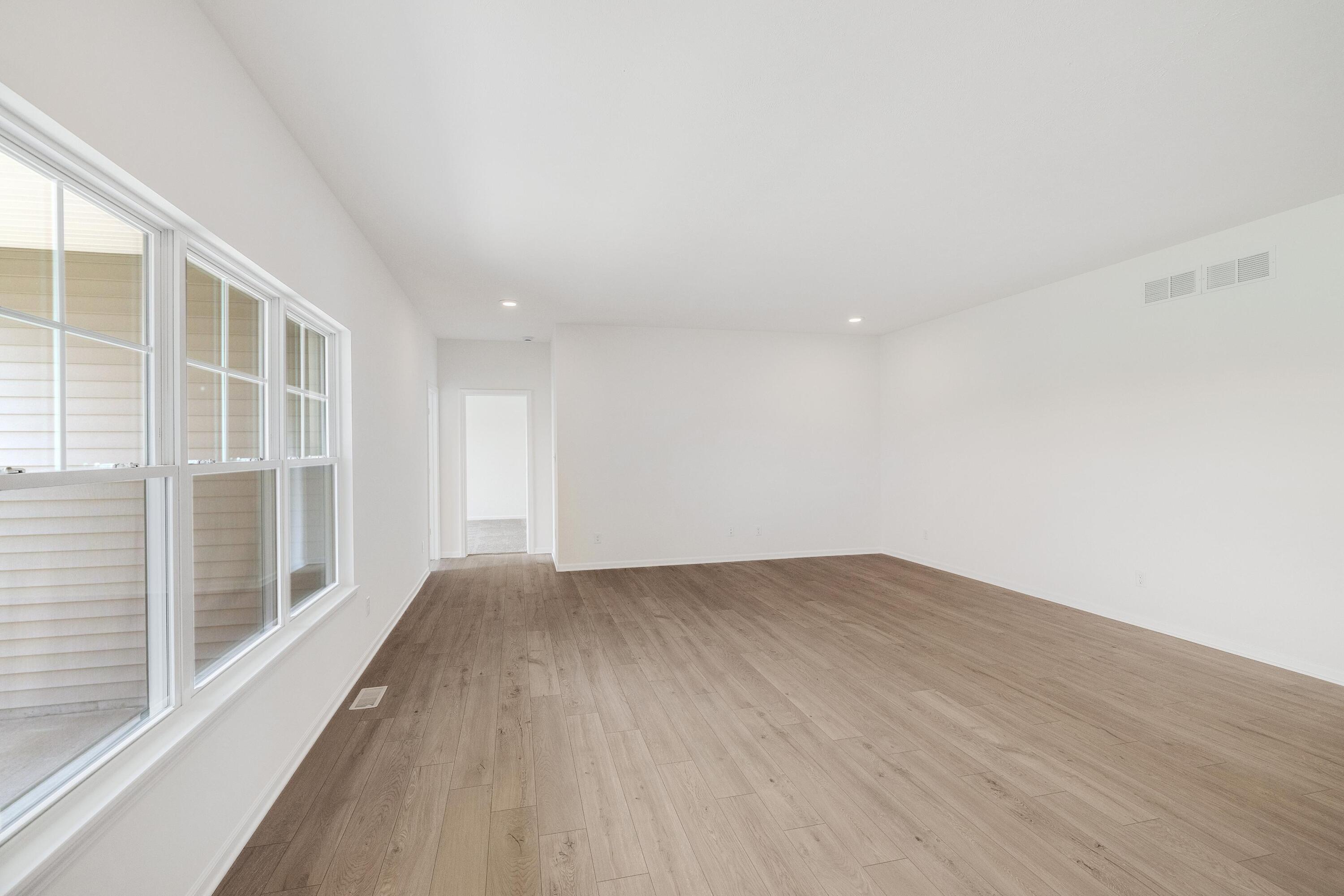 6821 Tucson Road Schererville, IN 46375 - Photo 12 of 24 a view of an empty room with wooden floor and a window