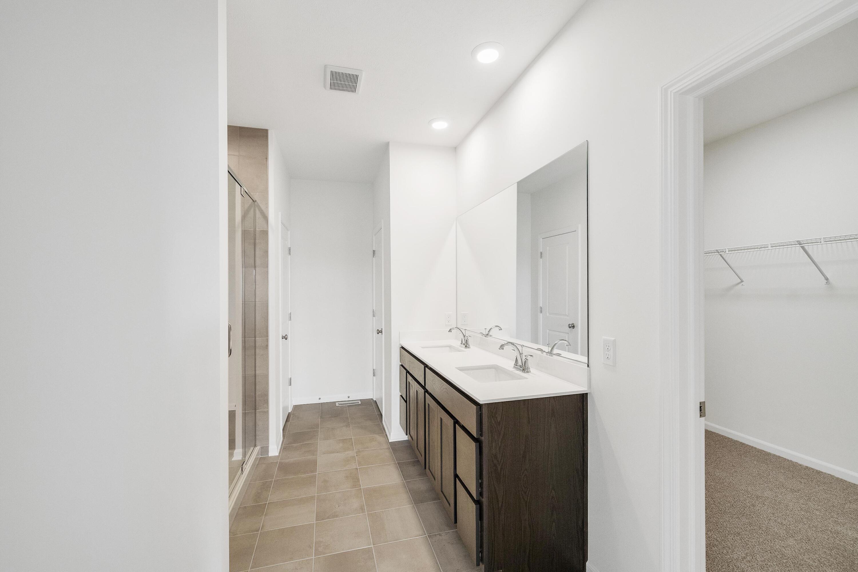 6821 Tucson Road Schererville, IN 46375 - Photo 20 of 24 a bathroom with a double vanity sink and mirror