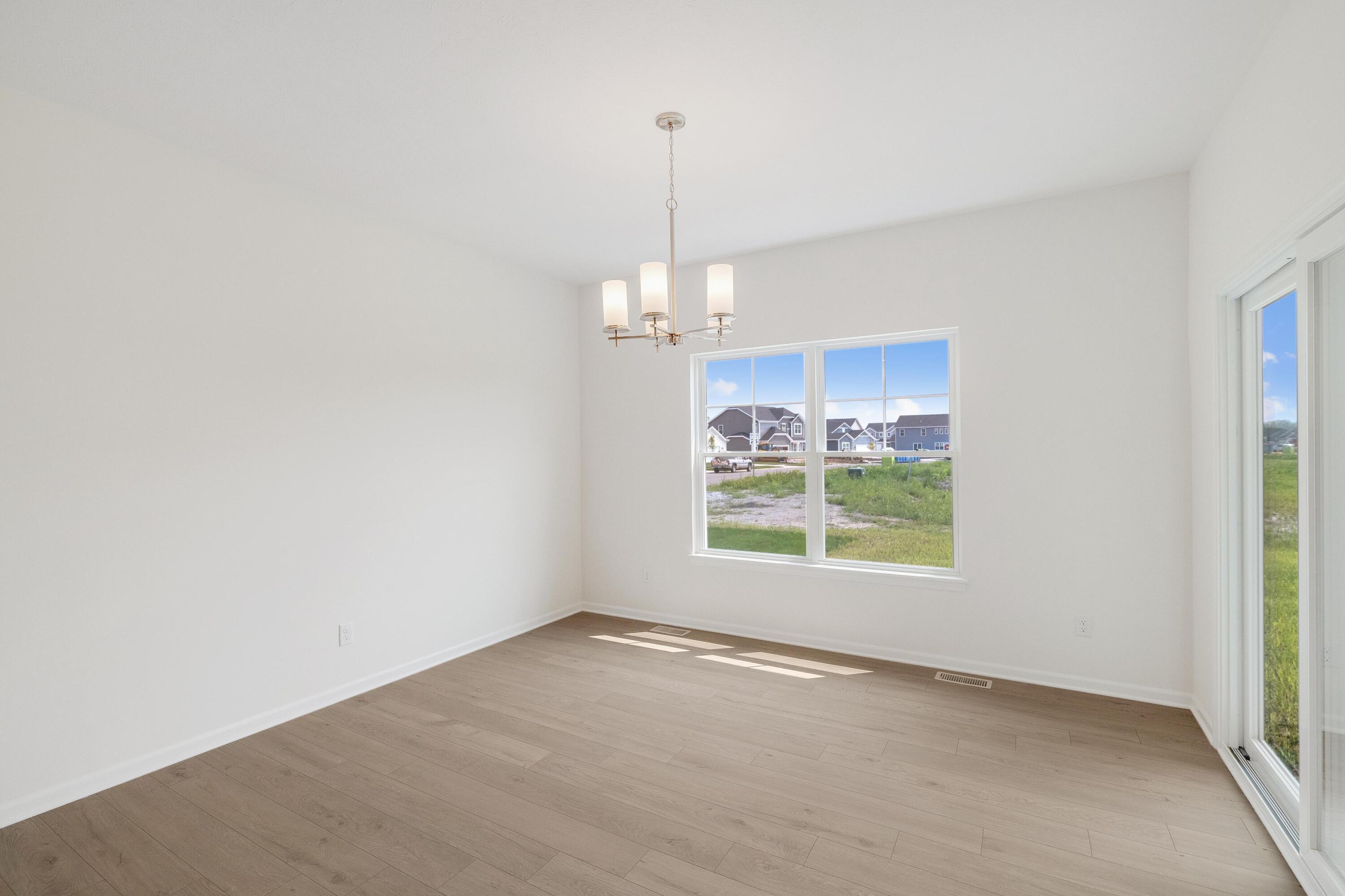 6821 Tucson Road Schererville, IN 46375 - Photo 10 of 24 an empty room with windows and chandelier