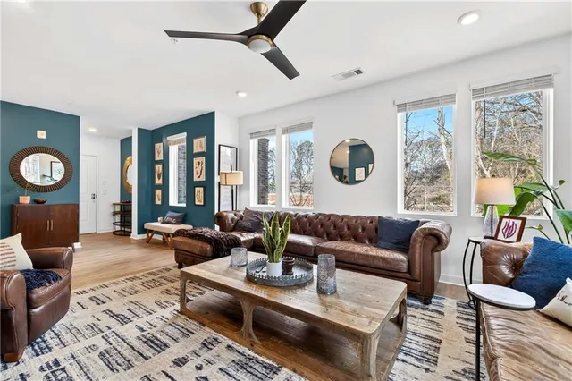 a living room with furniture couches and a large window