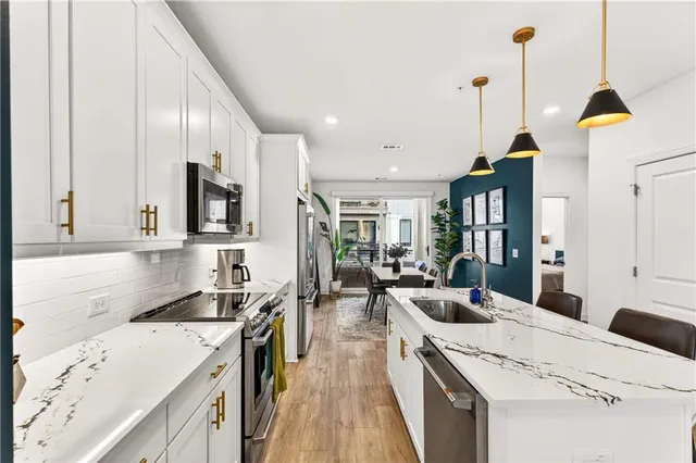 a kitchen that has a lot of cabinets in it