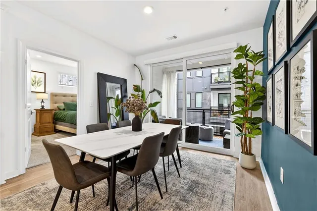 a view of a dining room with furniture and a potted plant