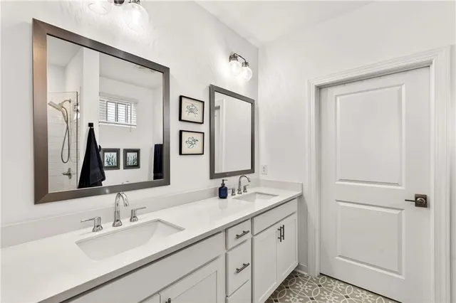 a bathroom with double vanity sink and a mirror