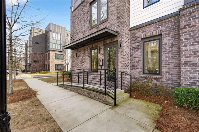 a view of a brick house with large windows