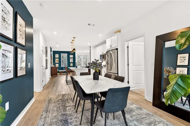 a dining room with furniture and a floor to ceiling window