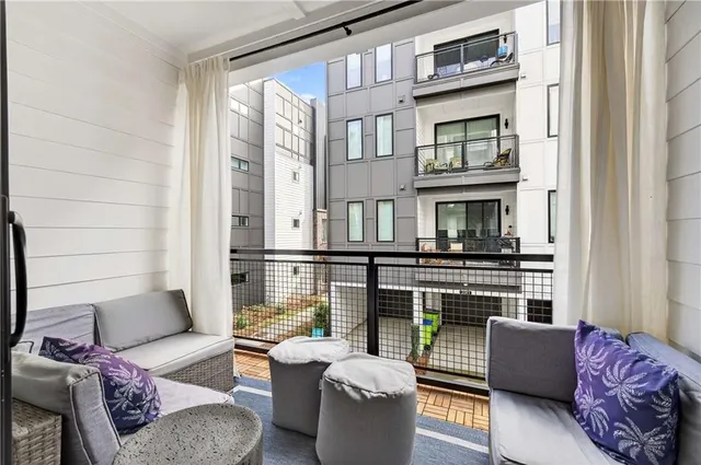 a outdoor living room with furniture and a fireplace