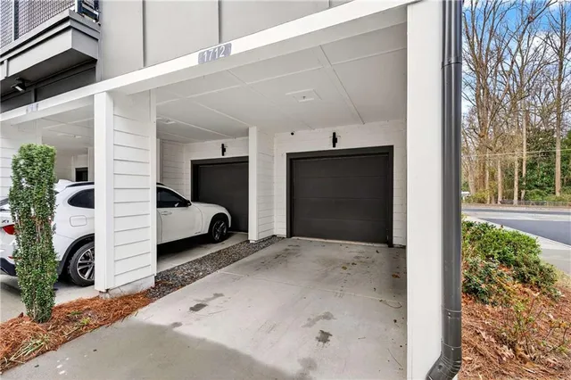 a view of a car garage door and two chair
