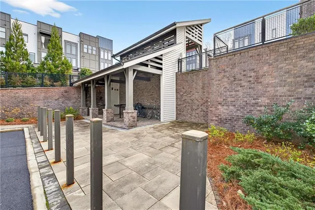 a patio with table and chairs and potted plants