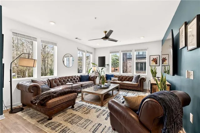 a living room with furniture ceiling fan and a rug