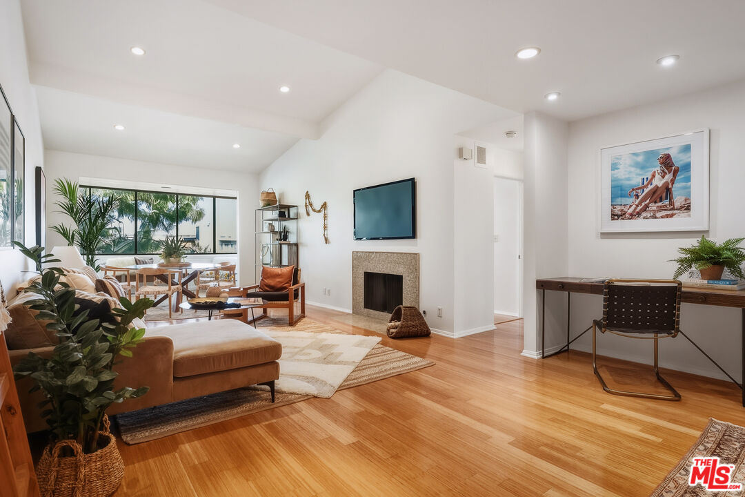 311 Bora Bora Way, Unit 315 Marina del Rey, CA 90292 - Photo 3 of 34 a living room with furniture a fireplace and a flat screen tv
