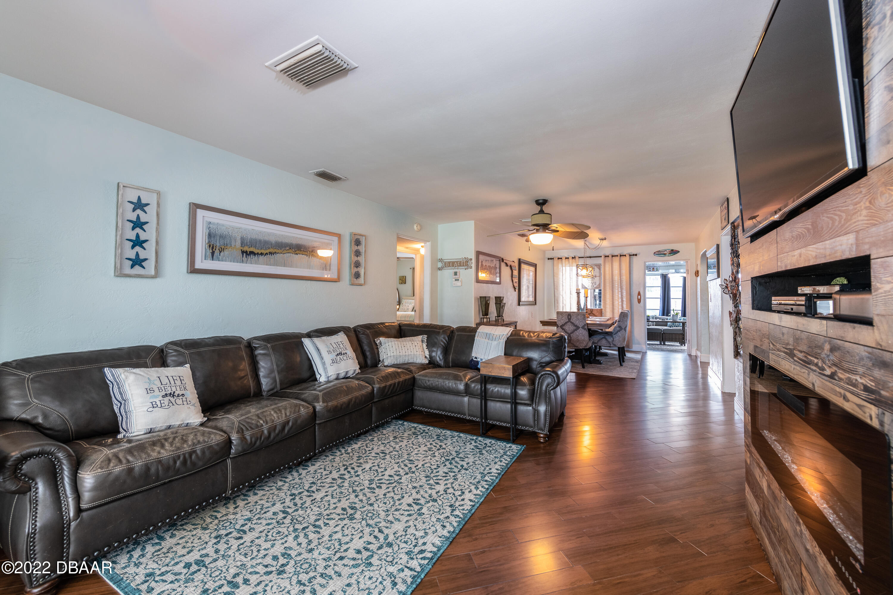 1253 Riverbreeze Boulevard Ormond Beach, FL 32176 - Photo 16 of 39 a living room with fireplace furniture and a flat screen tv