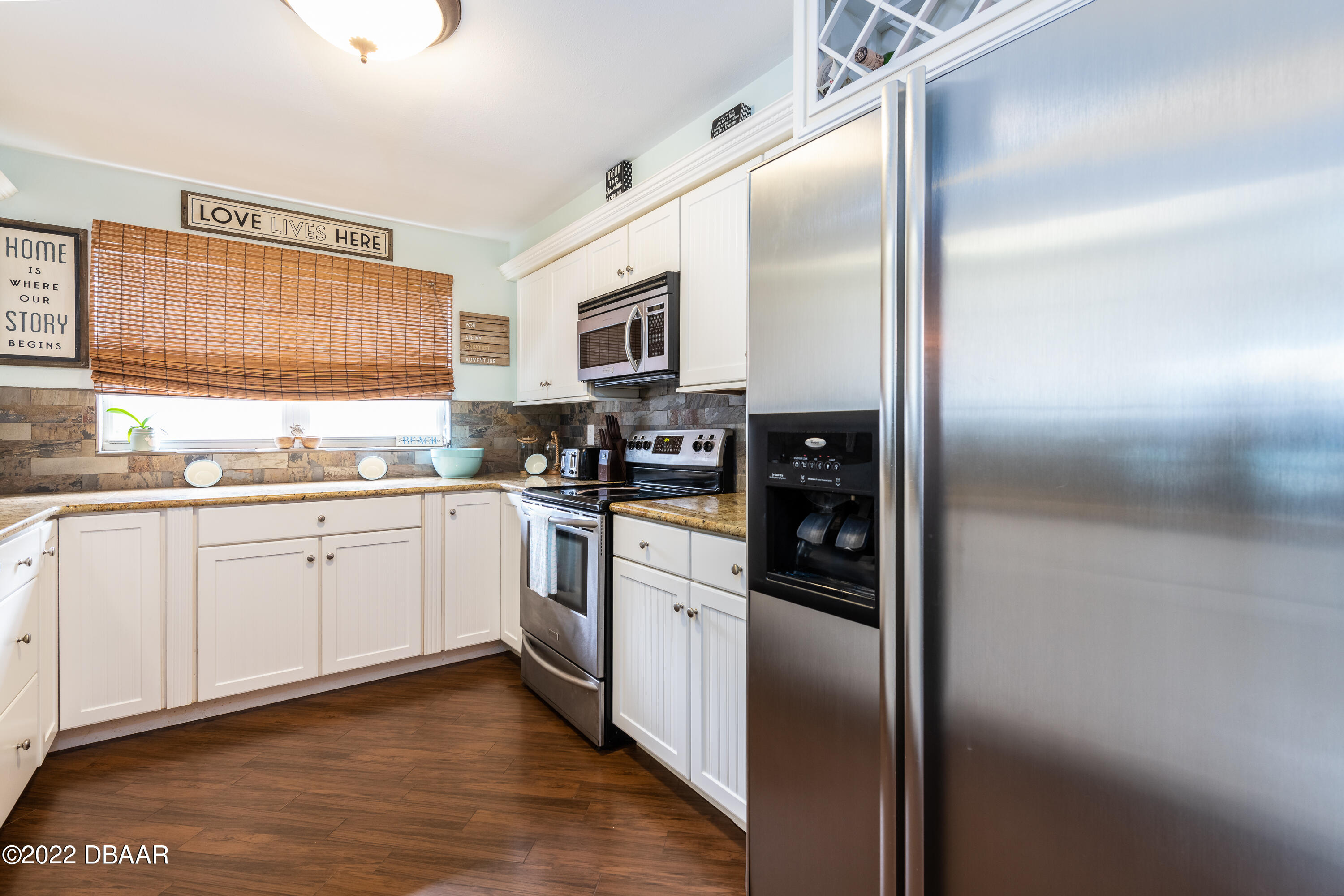 1253 Riverbreeze Boulevard Ormond Beach, FL 32176 - Photo 22 of 39 a kitchen with stainless steel appliances granite countertop a refrigerator a stove a sink and a window