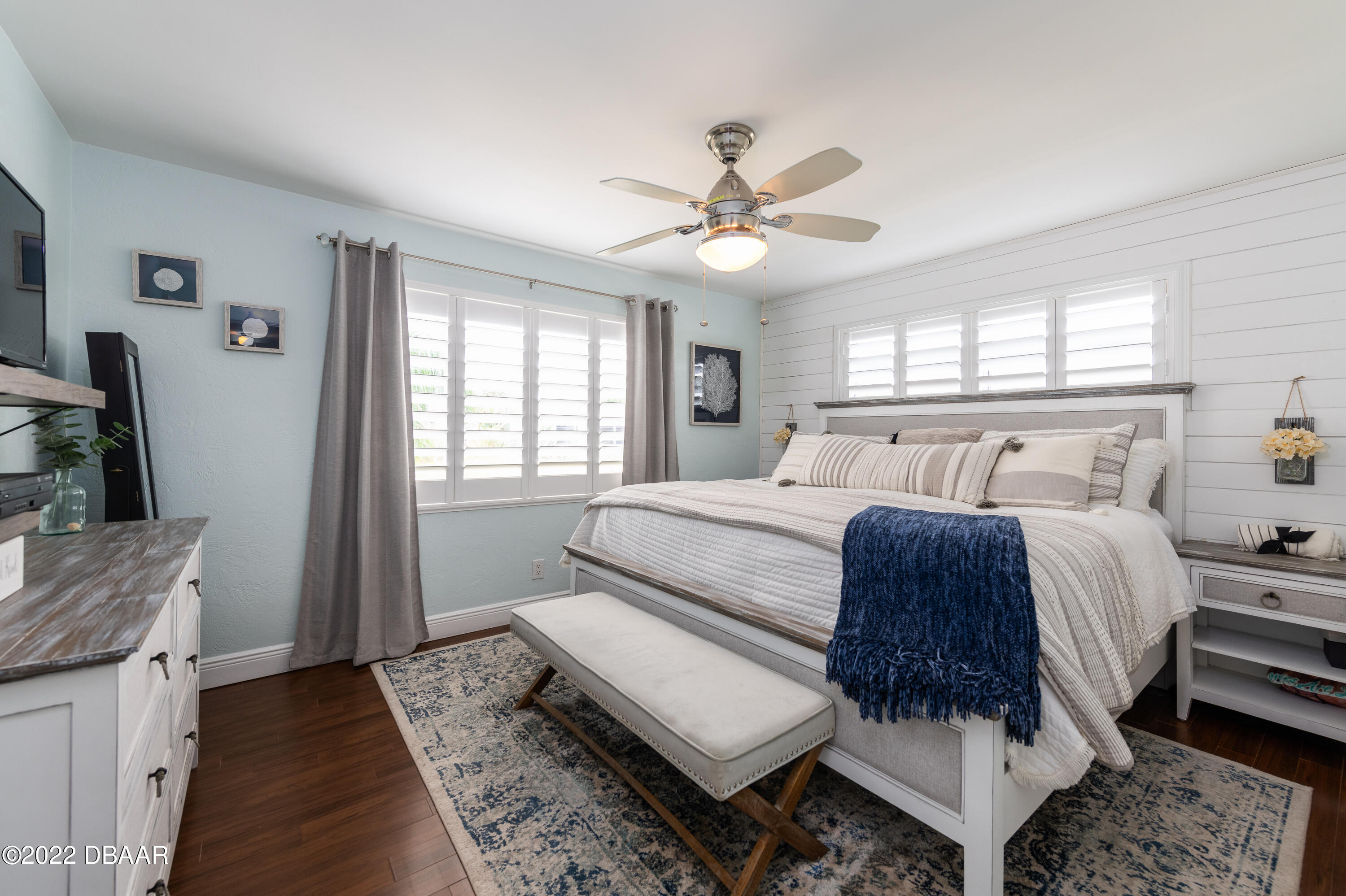 1253 Riverbreeze Boulevard Ormond Beach, FL 32176 - Photo 23 of 39 a bedroom with a large bed and a chandelier