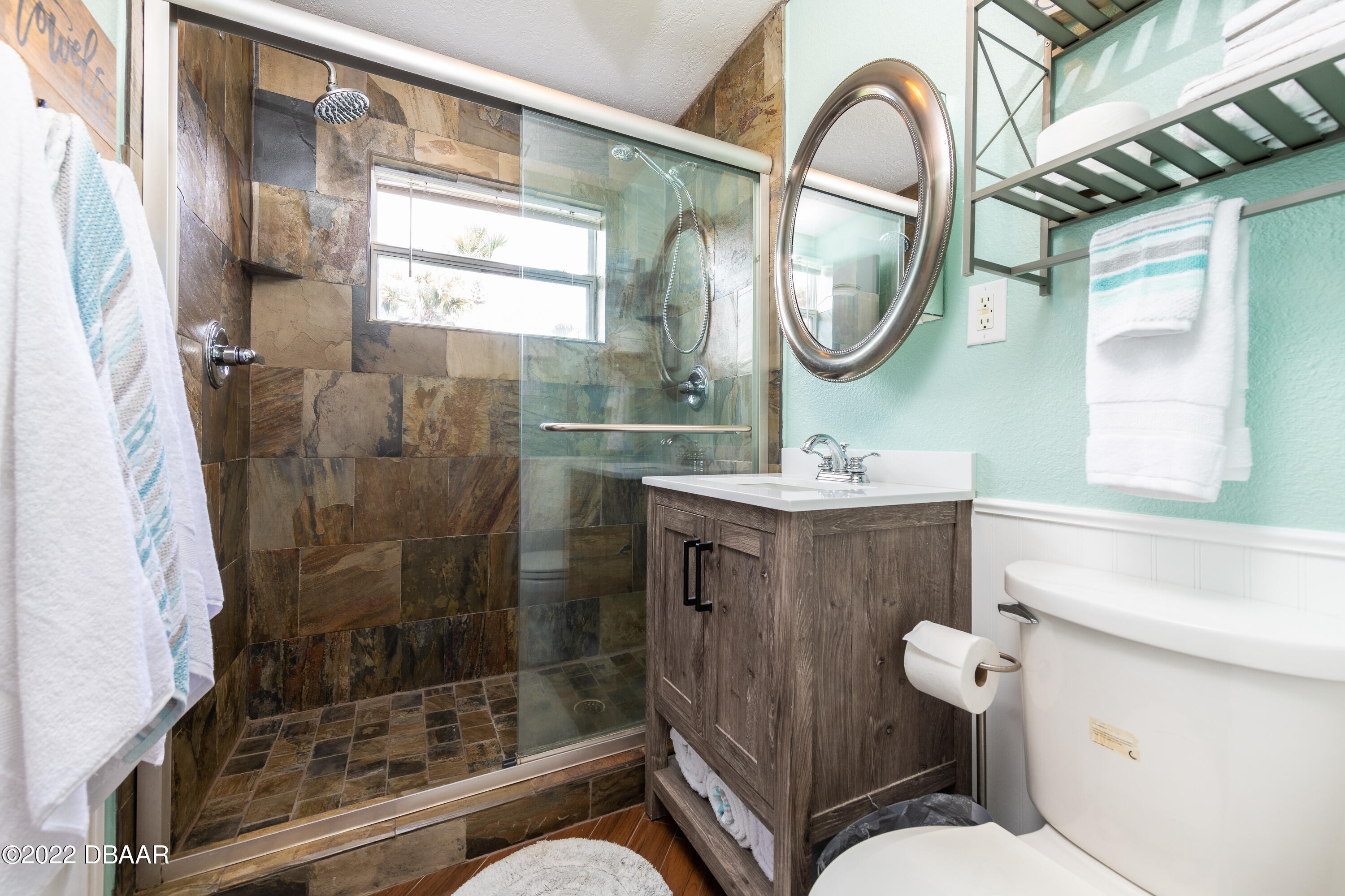 1253 Riverbreeze Boulevard Ormond Beach, FL 32176 - Photo 25 of 39 a bathroom with a sink a mirror a toilet and a shower