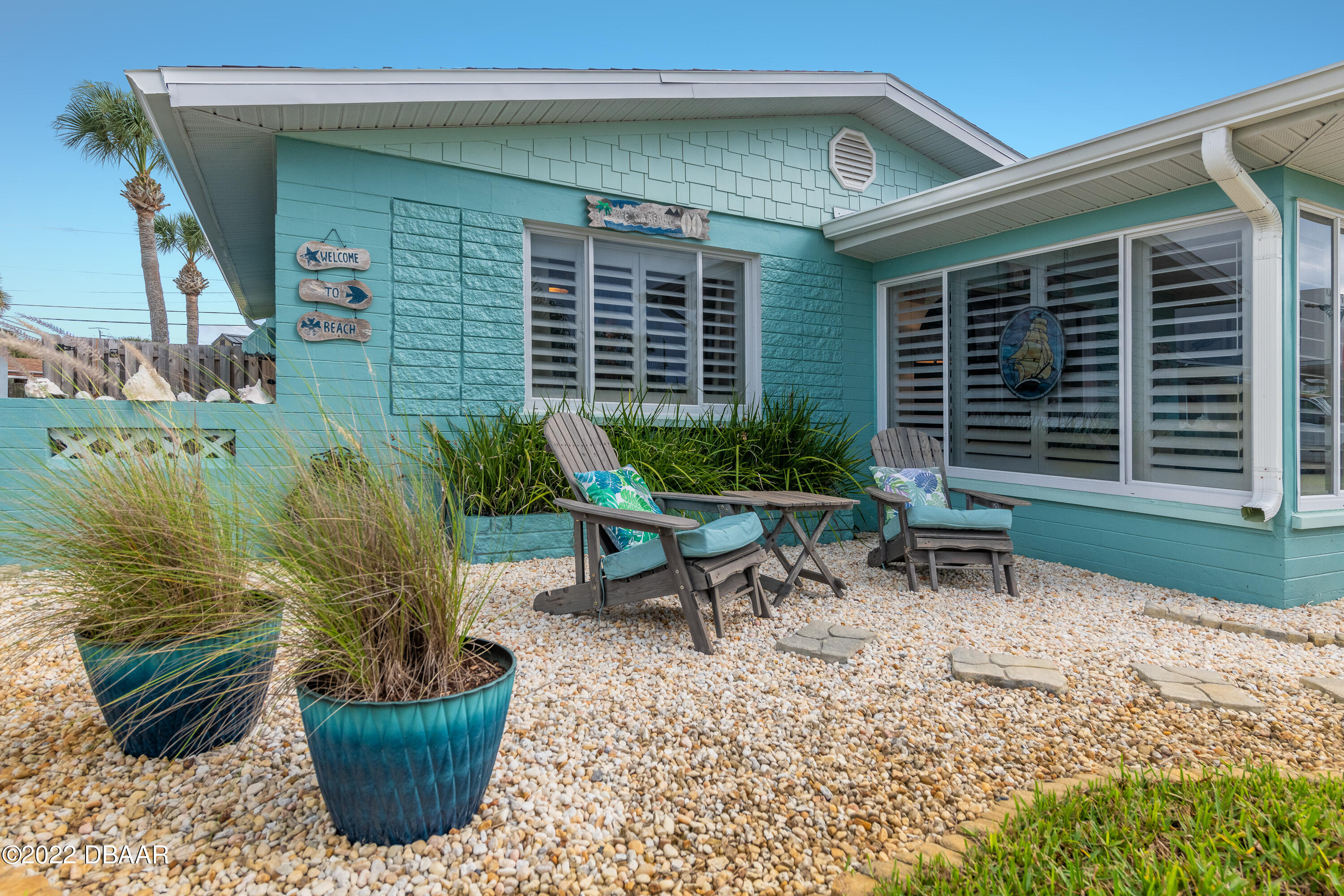 1253 Riverbreeze Boulevard Ormond Beach, FL 32176 - Photo 3 of 39 a view of a chairs and table in the back yard of the house