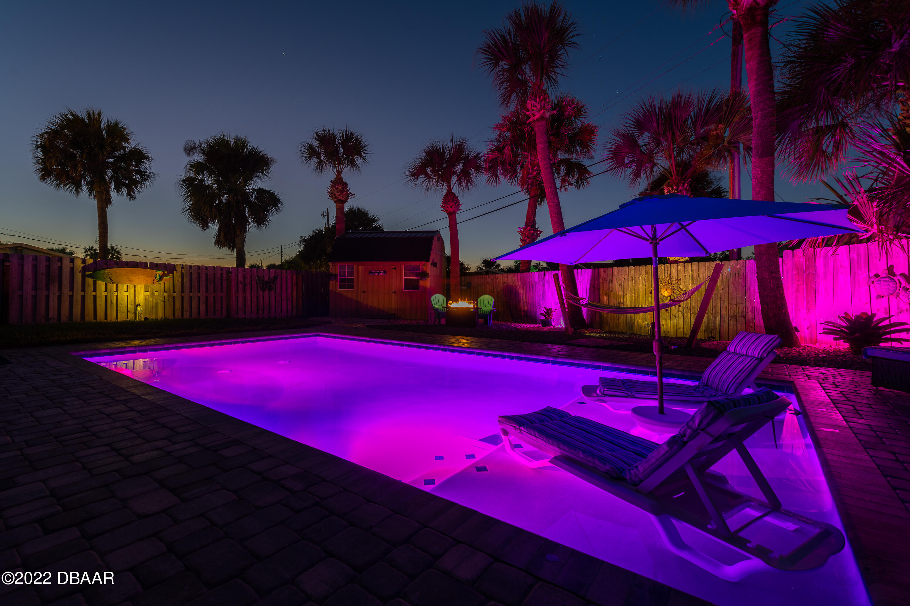 1253 Riverbreeze Boulevard Ormond Beach, FL 32176 - Photo 35 of 39 a view of swimming pool with lawn chairs under an umbrella