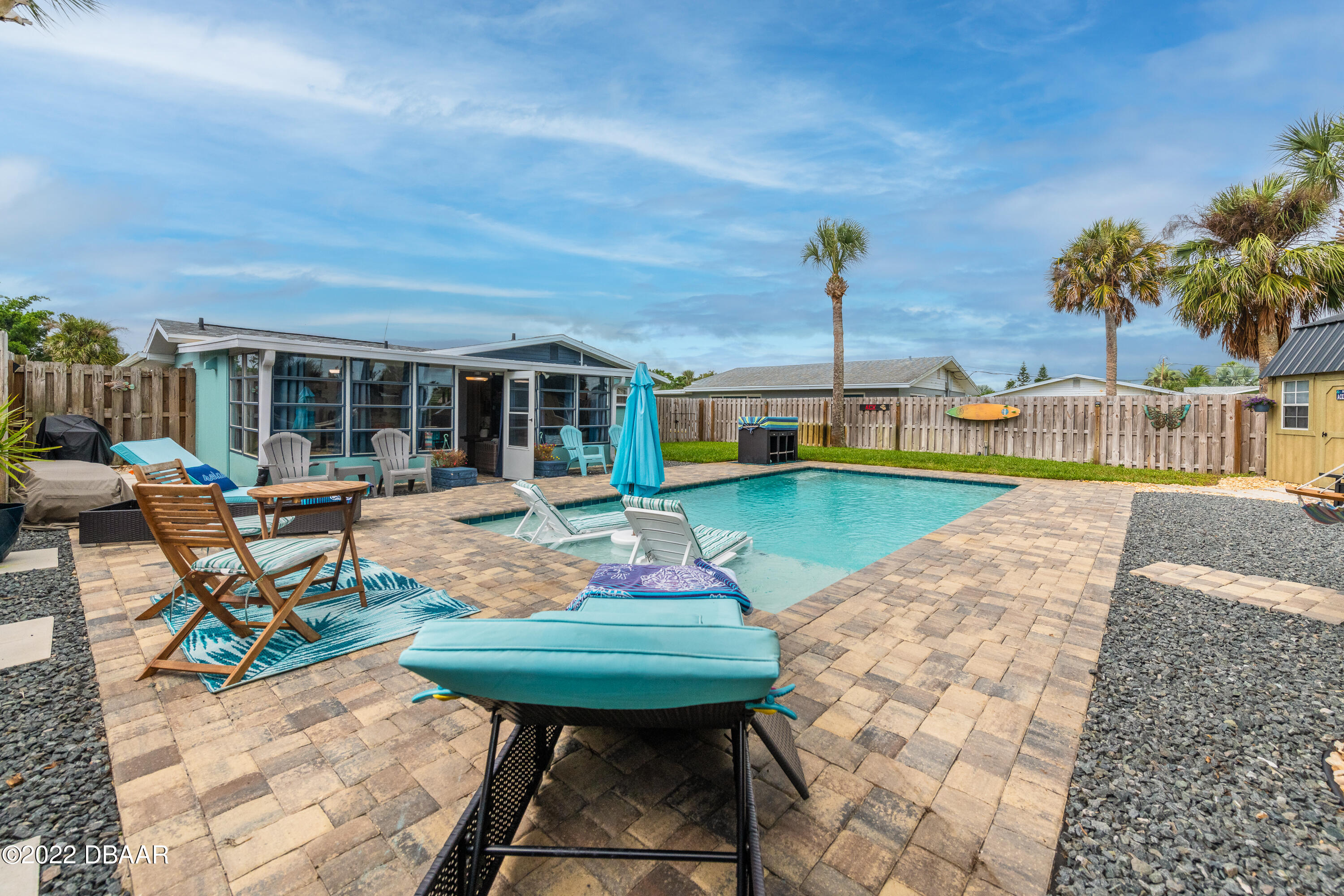 1253 Riverbreeze Boulevard Ormond Beach, FL 32176 - Photo 7 of 39 a view of a chairs and table in patio with a swimming pool
