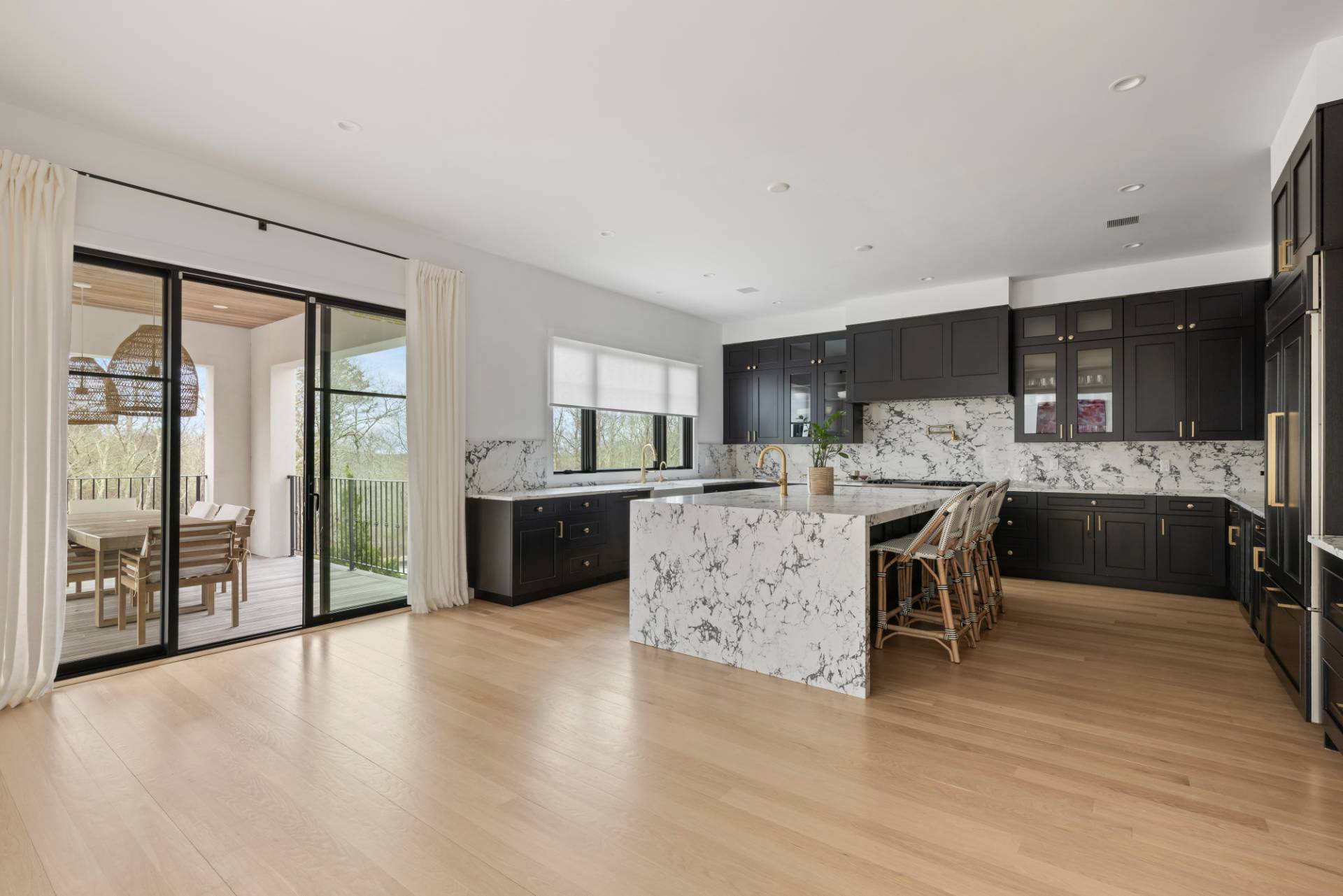 38 Chatfields Ridge Road East Hampton, NY 11937 - Photo 5 of 27 a kitchen with stainless steel appliances kitchen island granite countertop a stove a sink a refrigerator and cabinets