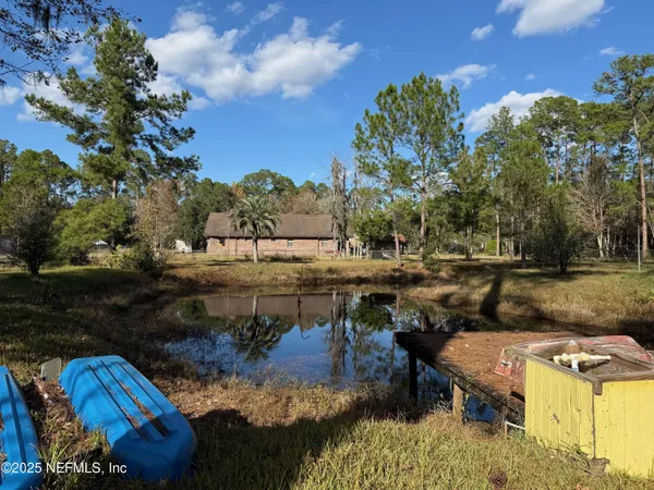 a view of swimming pool with large trees
