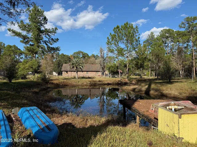 a view of swimming pool with large trees