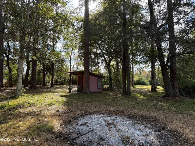 a view of a house with a yard covered in snow