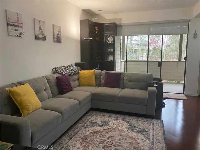 a living room with furniture and a floor to ceiling window