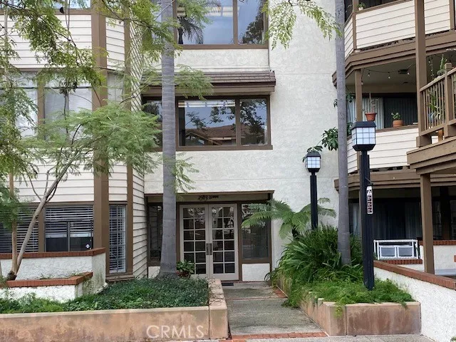 a front view of a house with plants