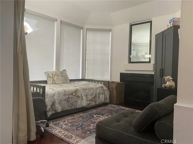 a bedroom with a bed couch and a window