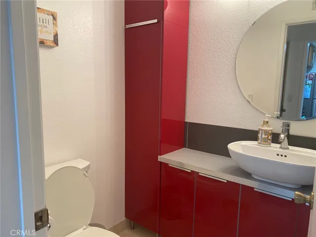a bathroom with a sink mirror and toilet