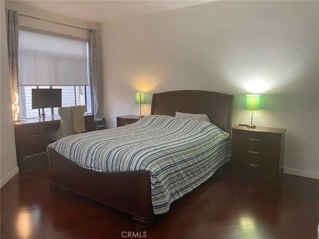 a bed sitting in a bedroom next to a lamp